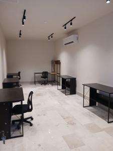 an empty room with desks and chairs in it at QUEEN ANGEL condo in Cozumel +44 photos