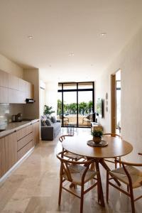 a kitchen and living room with a table and chairs at QUEEN ANGEL condo in Cozumel