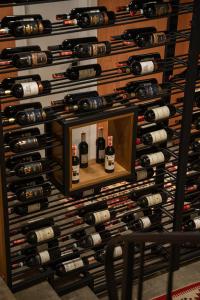 a wall of wine bottles in a wine cellar at Villa Garden Boutique Hotel Tirana in Tirana +134 photos