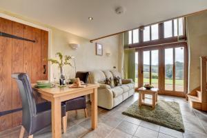 a living room with a table and a couch at 1 Bed in Tiverton oc-work in Bampton