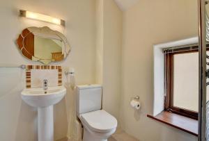 a bathroom with a toilet and a sink and a mirror at 1 Bed in Tiverton oc-work in Bampton +10 photos