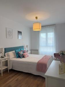 a bedroom with a large bed with colorful pillows at Orballo in Vilagarcia de Arousa +47 photos