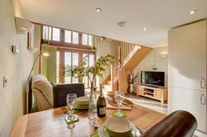 a dining room with a table with wine glasses at 1 Bed in Tiverton oc-work in Bampton
