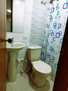 a bathroom with a toilet and a sink at Bohemia Hotel in Tunja +9 photos
