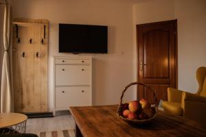 a living room with a basket of fruit on a table at Agroturystyka „Między Polami” in Zalewo