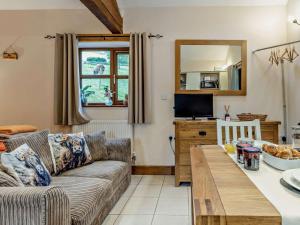 a living room with a couch and a table at 1 Bed in Llangammarch Wells oc-bn216 in Garth +18 photos
