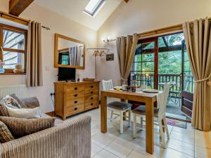 a living room with a table and a couch at 1 Bed in Llangammarch Wells oc-bn216 in Garth