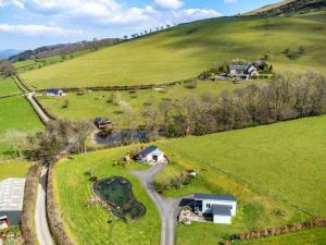an aerial view of a farm with a road at 1 Bed in Llangammarch Wells oc-bn216 in Garth