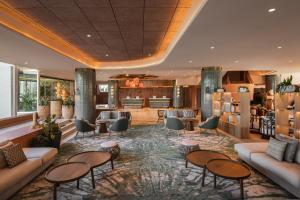 a lobby of a hotel with couches and tables at Hyatt Regency Vilamoura Algarve in Vilamoura