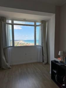 an empty living room with a large window at Camera Deluxe in favoloso attico vista mare in Rimini