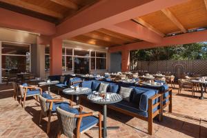 a restaurant with tables and chairs on a patio at Hyatt Regency Vilamoura Algarve in Vilamoura