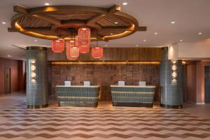 a lobby of a hotel with red chandeliers at Hyatt Regency Vilamoura Algarve in Vilamoura +72 photos