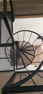 a metal chair sitting on top of a wooden floor at LOFTb , EN EL CORAZON DE SALTA in Salta