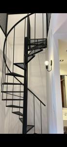 a black spiral staircase in a white building at LOFTb , EN EL CORAZON DE SALTA in Salta