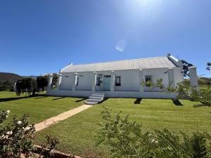 a large white house with a grass yard at Firgrove Country House in Robertson +43 photos