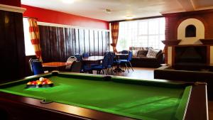a living room with a green pool table at Secluded Seven Room House in Okehampton +8 photos