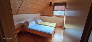 a small room with a bed and a window at Vila Two in Cârțișoara