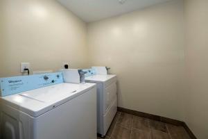 a laundry room with a washer and dryer at Red Roof Inn Lumberton in Lumberton +25 photos