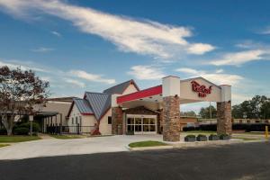 a fast food restaurant with a sign on the building at Red Roof Inn Lumberton in Lumberton