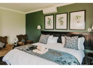 a bedroom with a large bed with a hat on it at Aloe Corner, Cathkin Estates by Euphoric Leisure in Ardmore