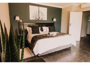 a bedroom with a bed and a cactus at Aloe Corner, Cathkin Estates by Euphoric Leisure in Ardmore