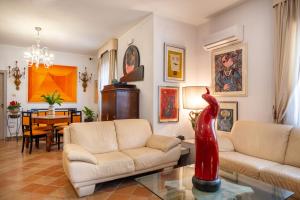a living room with two couches and a table at L'Elisea Maison De Charme in Castellabate