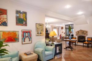 a living room with paintings on the walls at L'Elisea Maison De Charme in Castellabate