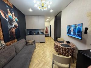a living room with a couch and a table at Байсанат 2 in Karagandy