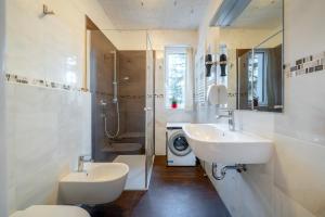 a bathroom with two sinks and a washing machine at Gardar in Bolzano +43 photos