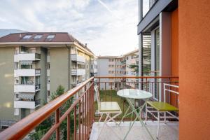 a balcony with a table and chairs and some buildings at Gardar in Bolzano