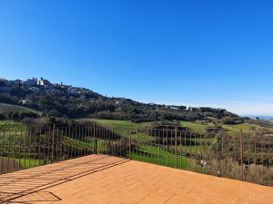 a balcony with a view of a hill at Il Casale del Priore in Todi