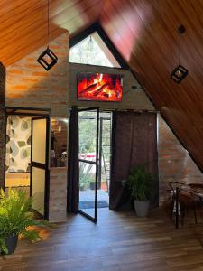 a living room with a fireplace in a house at Killa Glamping in Sangolquí