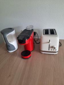 two toasters and a toaster on a wooden table at Studio proche océan dans résidence 3 étoiles avec piscine et parking privé in Mimizan-Plage