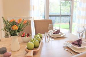 a wooden table with fruits and vegetables on it at Quartier Spreestraße - App 2 in Burg