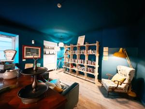 a blue living room with a couch and a book shelf at Hotel Britannia in Genoa