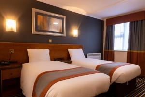 a hotel room with two beds and a window at Weathervane Hotel by Greene King Inns in Stoke on Trent +18 photos