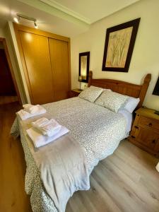 a bedroom with a bed with two towels on it at Can Rios-Felechosa - Aller in Felechosa