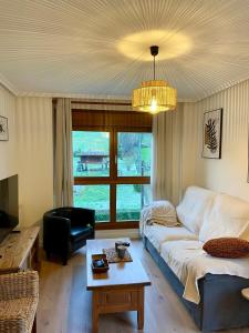 a living room with a couch and a table at Can Rios-Felechosa - Aller in Felechosa