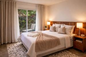a bedroom with a large bed and a large window at Pousada Águas do Alto in São Francisco Xavier +52 photos