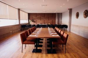 a large dining room with a long table and chairs at The Prime Energize Hotel & SPA - Algarve in Monte Gordo +136 photos