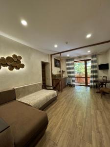 a living room with a couch and a table at База отдыха Дубки in Orlovshchina