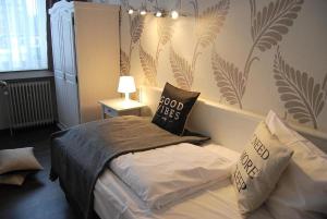 a bedroom with a bed with pillows on it at Aachener Stadthotel in Aachen