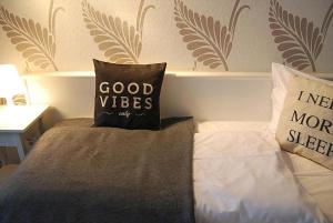 a bed with two pillows on top of it at Aachener Stadthotel in Aachen