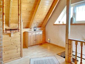 an attic room with a staircase and a window at Eisvogel in Lübbenau +17 photos