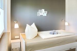a bed with two pillows and a stuffed animal on it at Dobra in Lübbenau +6 photos