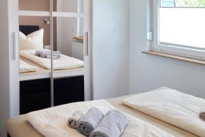 a bedroom with two beds and a mirror at Dobra in Lübbenau