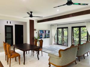 a dining room with a table and chairs at Ornella Villa in Yogyakarta +3 photos