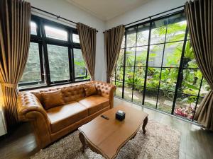 a living room with a couch and a coffee table at Ornella Villa in Yogyakarta
