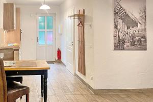 a kitchen with a table and a dining room at Laubhütte Baum 1 in Burg