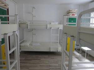 a room with three bunk beds in a room at A Barca de Pedra in Padrón +17 photos